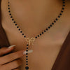 Imitation Pearl Tassel Y Necklace with Bow in Black or White - Image 1