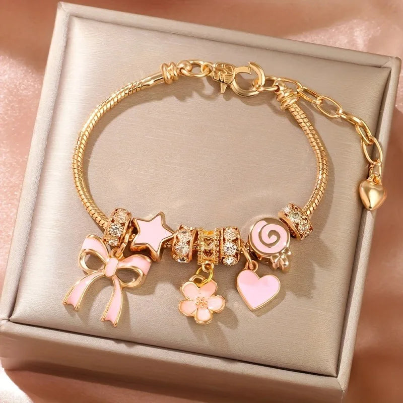 Heart-Shaped Bracelet with Bow Detail in Gold-Tone - Image 1