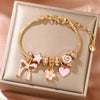 Heart-Shaped Bracelet with Bow Detail in Gold-Tone - Image 1