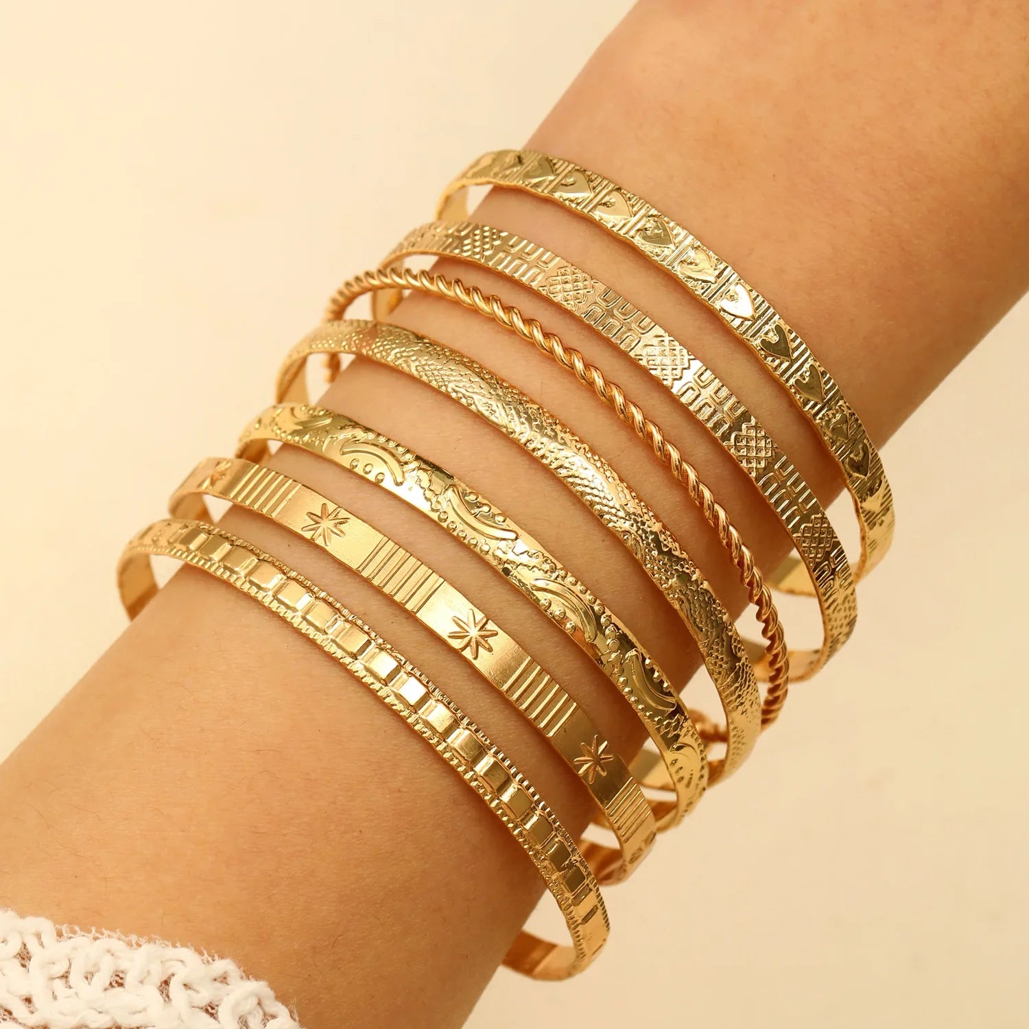 Seven-Piece Metal Bangle Set with Heart Motifs in Gold-Tone or Silver-Tone - Image 1