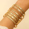 Seven-Piece Metal Bangle Set with Heart Motifs in Gold-Tone or Silver-Tone - Image 1
