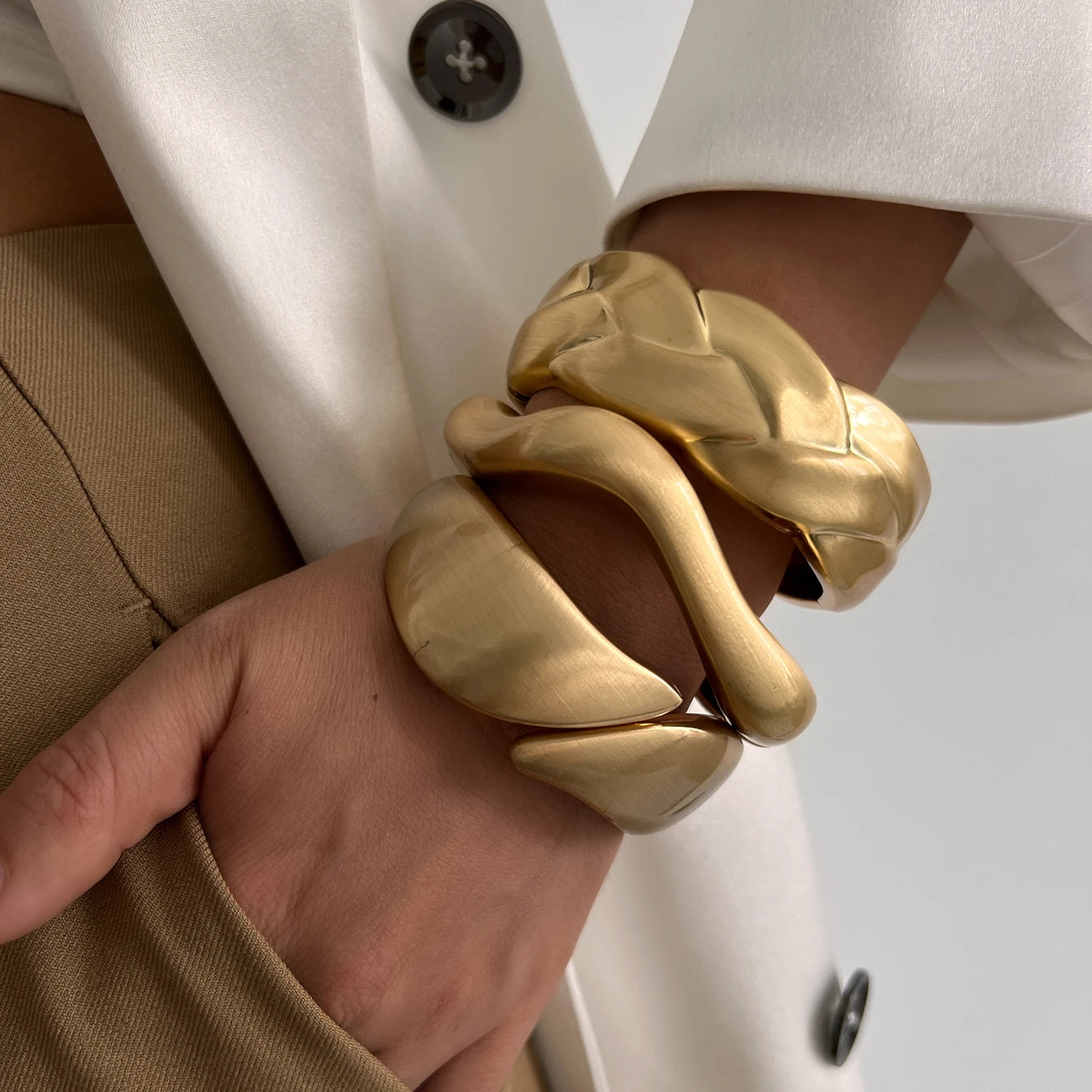 Wide Wave Cuff Bangle in Matte Gold-Tone and Silver-Tone Alloy - Image 1