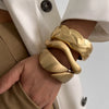 Wide Wave Cuff Bangle in Matte Gold-Tone and Silver-Tone Alloy - Image 1