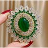Green Oval Sunburst Brooch with Clear Accents - Image 1
