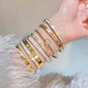Stainless Steel Bangle Bracelet with Cubic Zirconia Details in Gold-Tone or Silver-Tone - Image 2