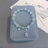 Blue Stone Bead Bracelet with Oval Pendant and Adjustable Fit - Image 1