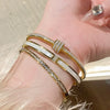Stainless Steel Bangle Bracelet with Cubic Zirconia Details in Gold-Tone or Silver-Tone - Image 3