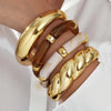 Four-Piece Brown Resin Bangle Set in Gold-Tone - Image 1