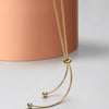 Gold-tone snake chain and adjustable bead detail